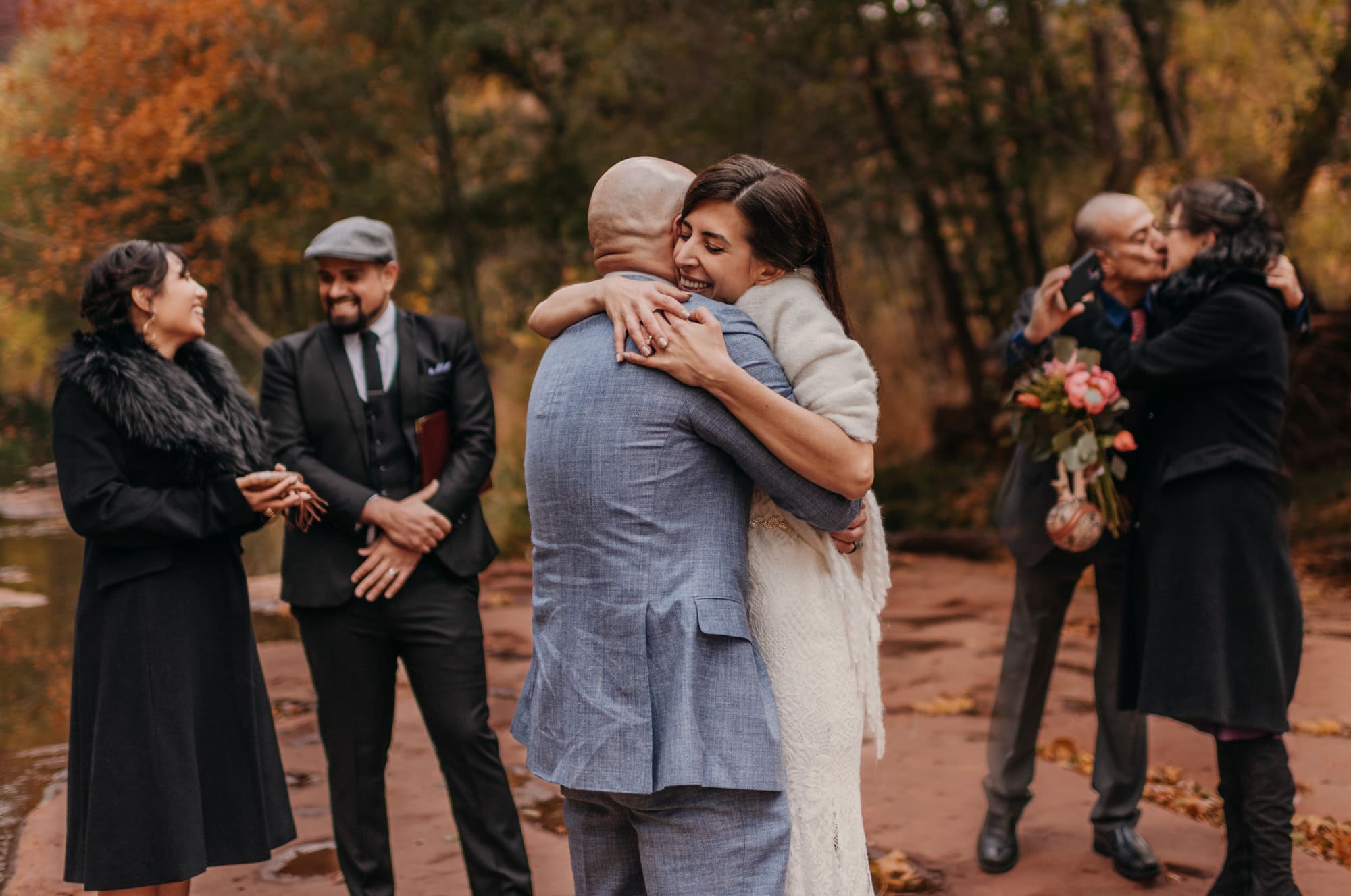 A bride hugs her groom after becoming married.