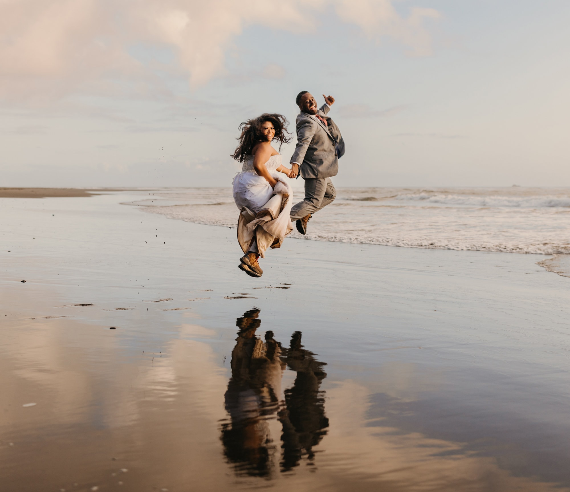 A couple jumps in glee on the coast of Olympic National Park on their elopement day.