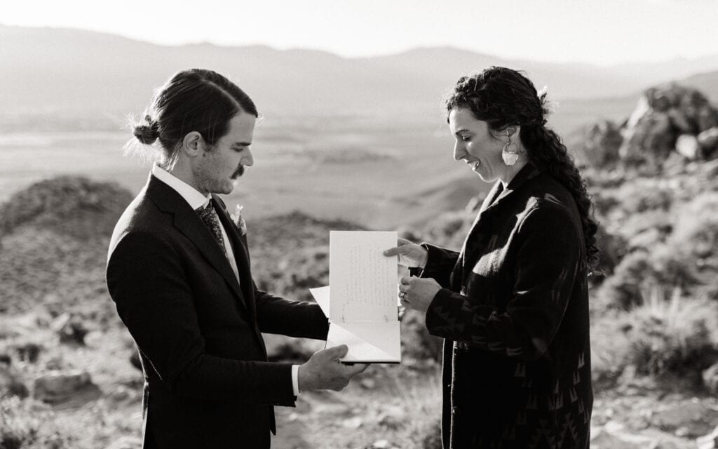 The couple prepares for their ceremony arranging the pages of their vow book.