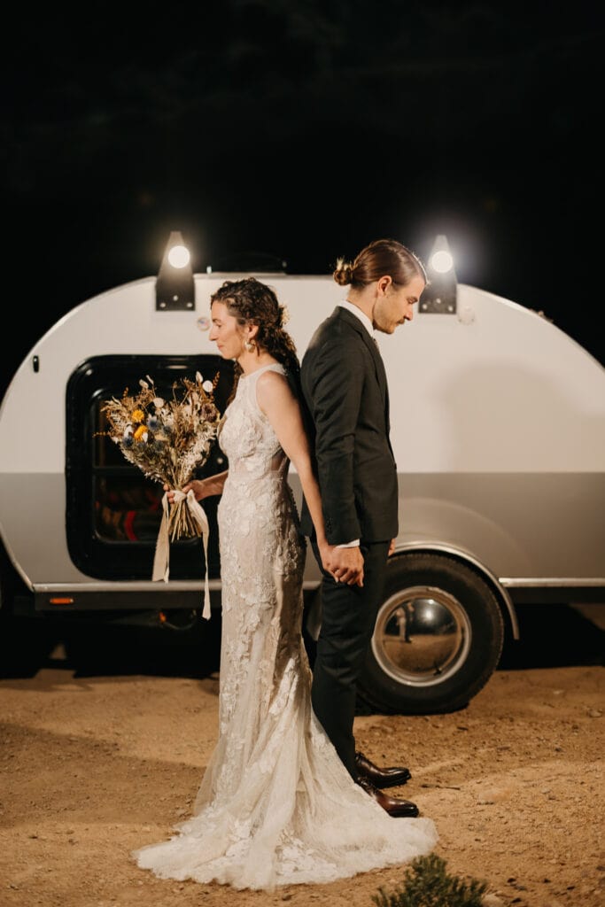 The couple turns back to back before seeing each other for the first time in their wedding attire.