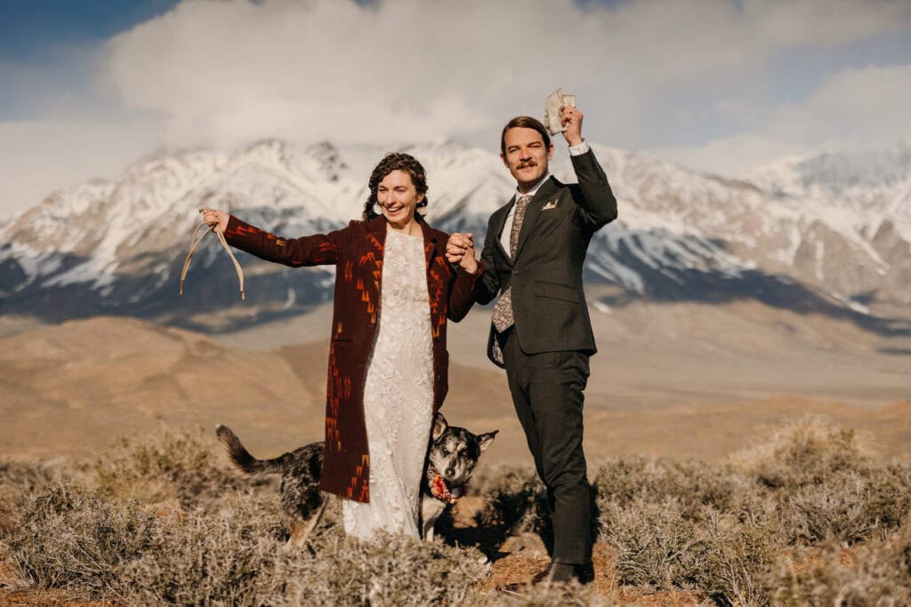 The couple raises their hands in celebration of officially becoming married.