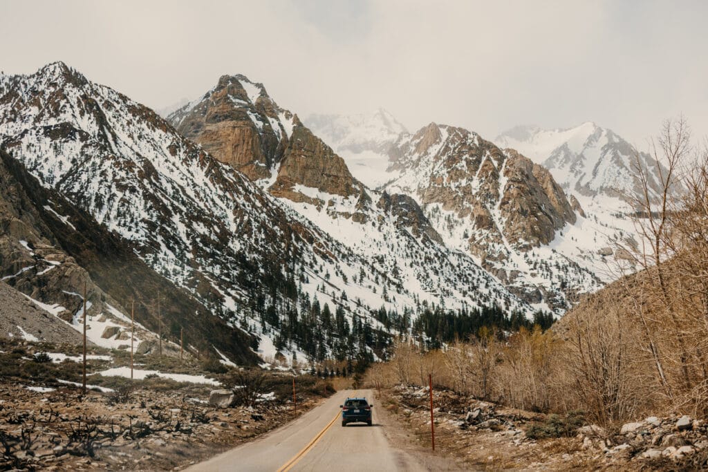 The couple drives into the mountains of bishop on their elopement day.