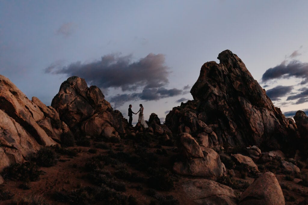 A photo of the couple as they hike up the mountain of Bishop as dawn starts to arrive.