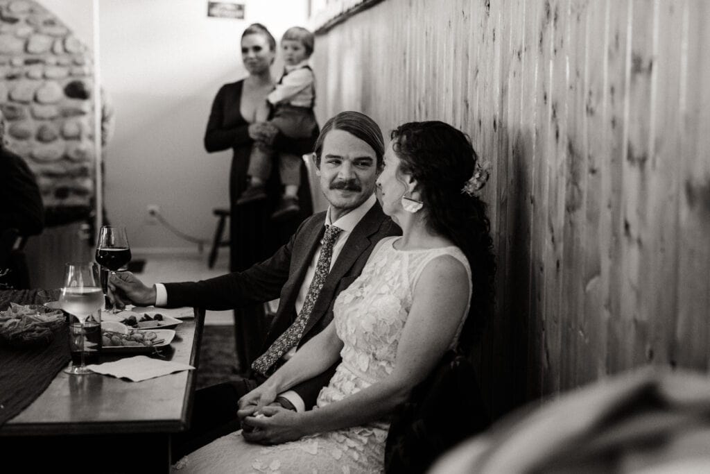 The groom looks at the bride lovingly during the speeches.