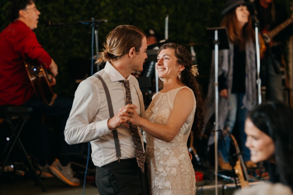 The bride and groom share a first dance together.