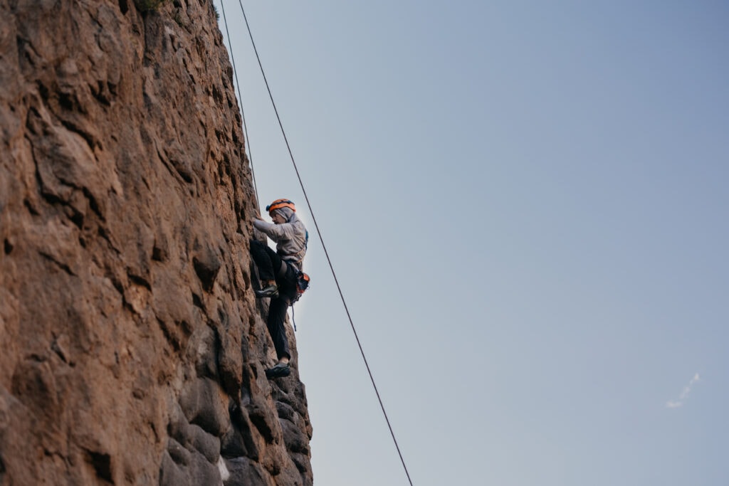 The groom climbs a sport route.