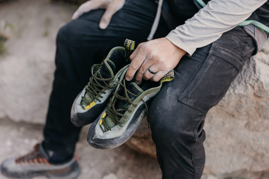 A detail photo of the grooms climbing shoes and his wedding ring.