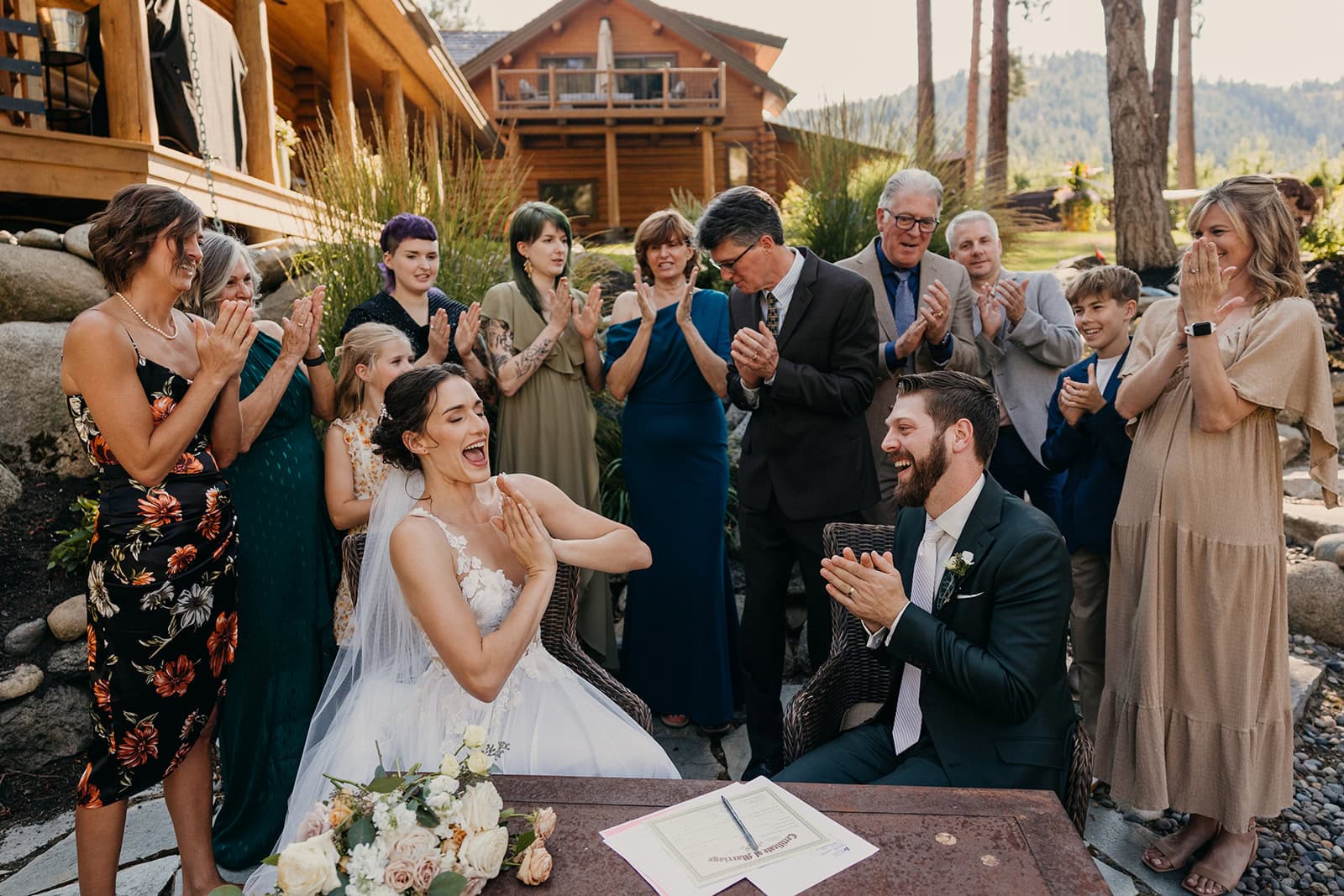 Family and friends witnessing signing the marriage certificate.