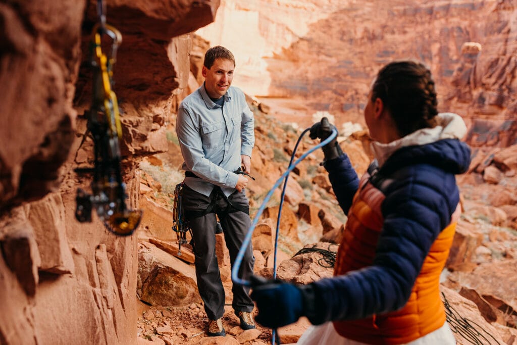 A groom gears up for a climb in Moab.