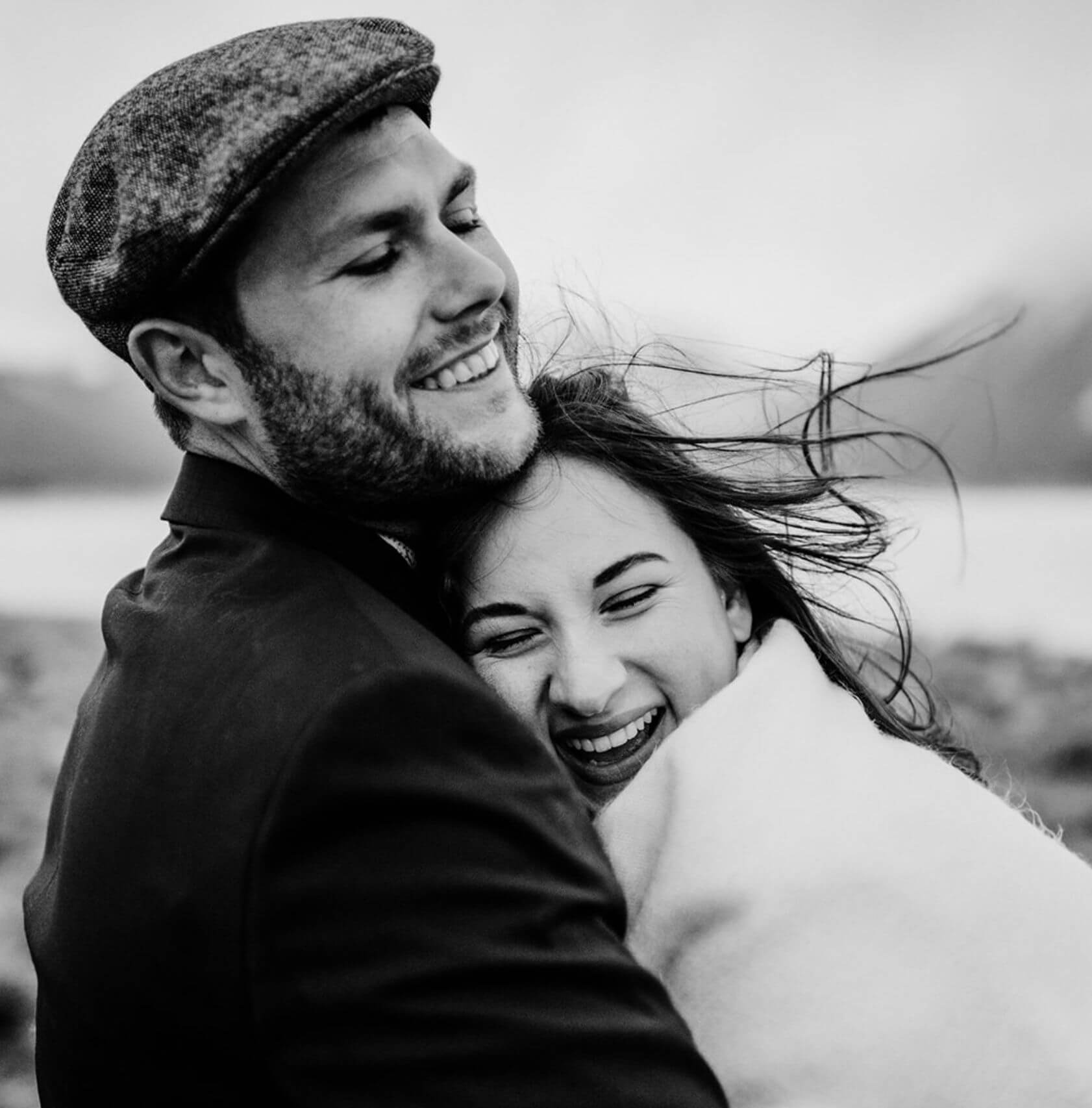 A couple hugging each other and laughing