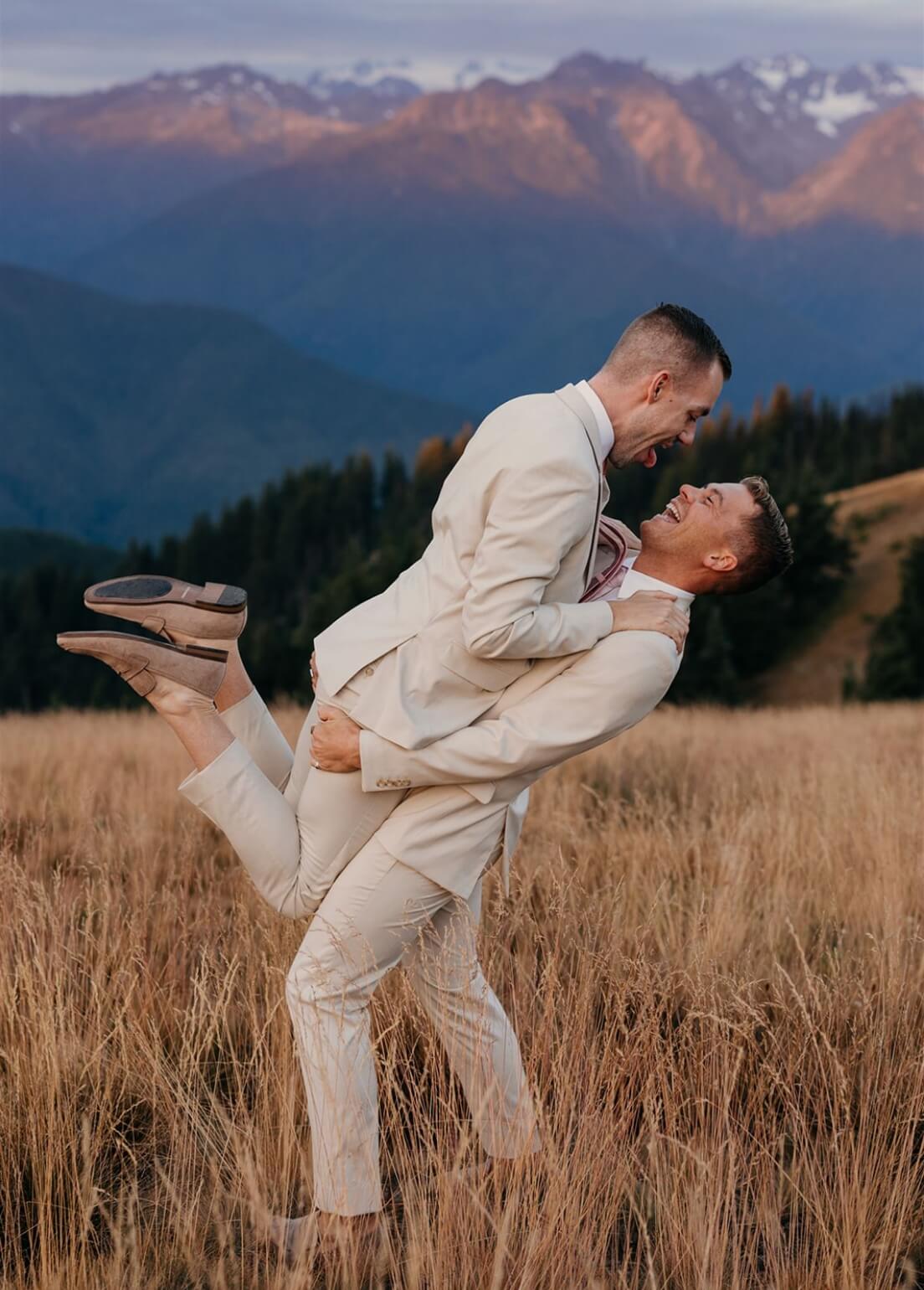 A person picking up their partner as they both laugh and smile 