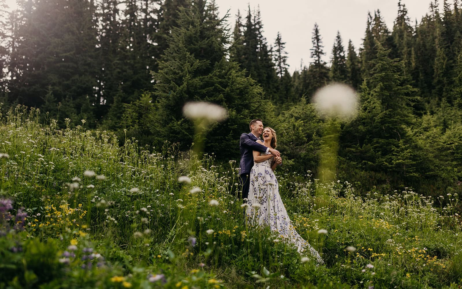 A couple stands on a trail together during their elopement in the mountains on a summer day.