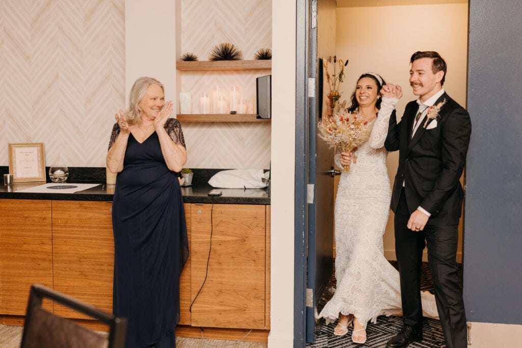 The bride and groom arrive to their reception space