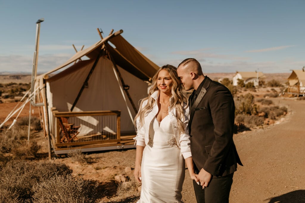 A bride and groom leave their camp site for their wedding.