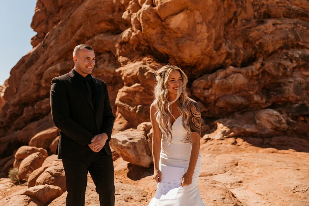 The bride smiles and is surprised when she finds out she was gifted video from a letter her sister gave her.