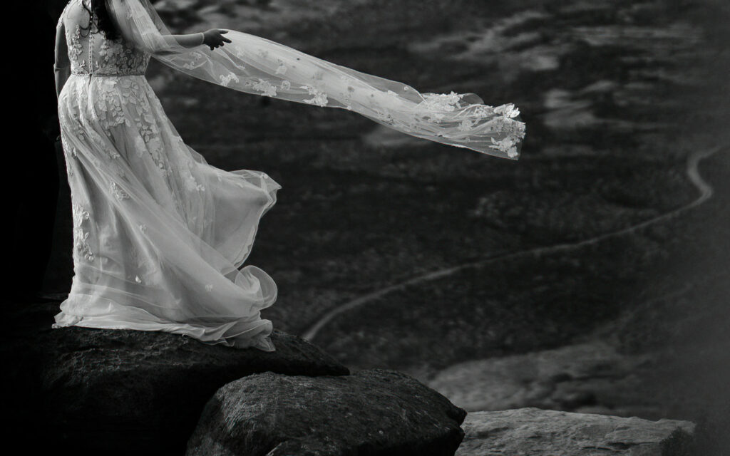 The bride catches her veil in the wind.