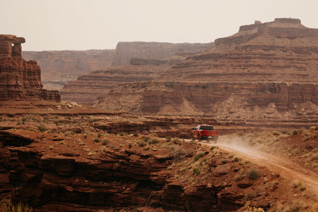 The couple off roads in their truck.