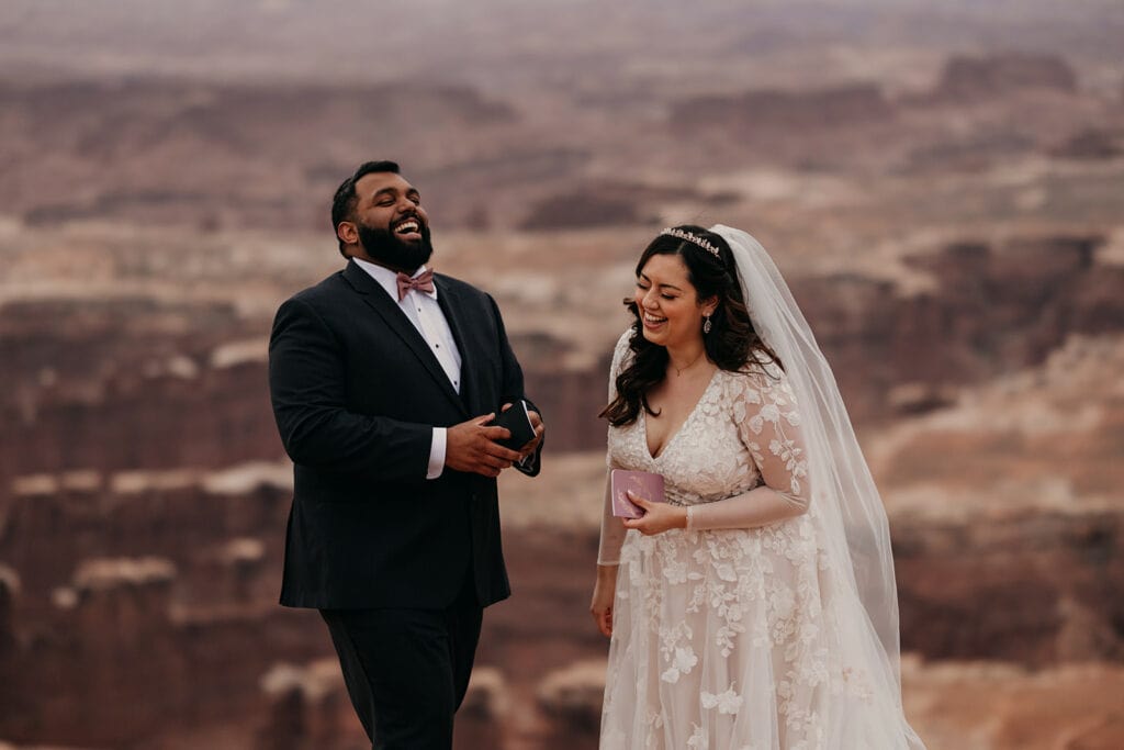 The couple laughs as they start to share their vows.