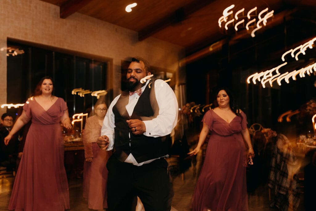 The groom dances at the reception.