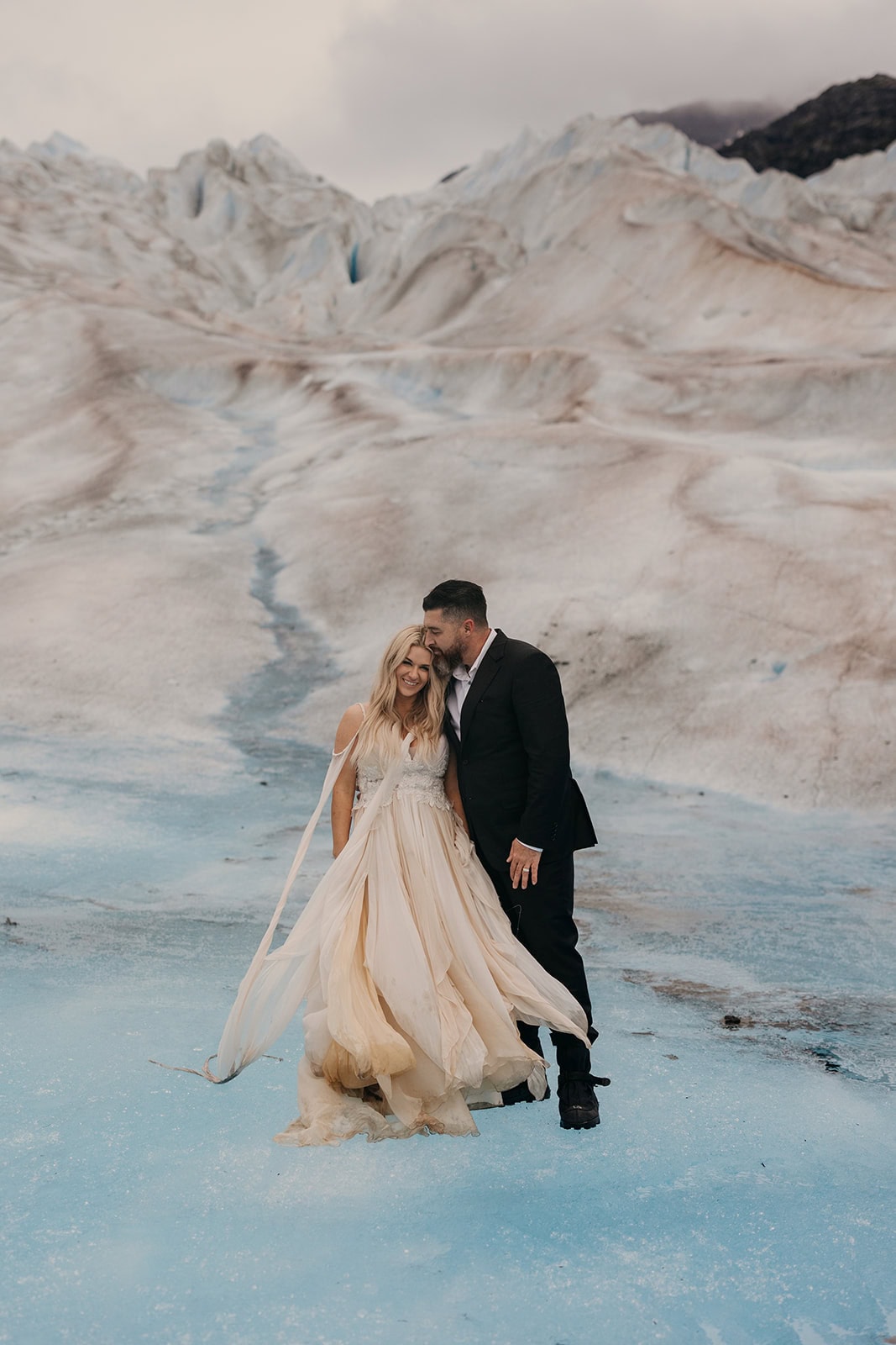 A portrait of a bride and groom on a glacier.