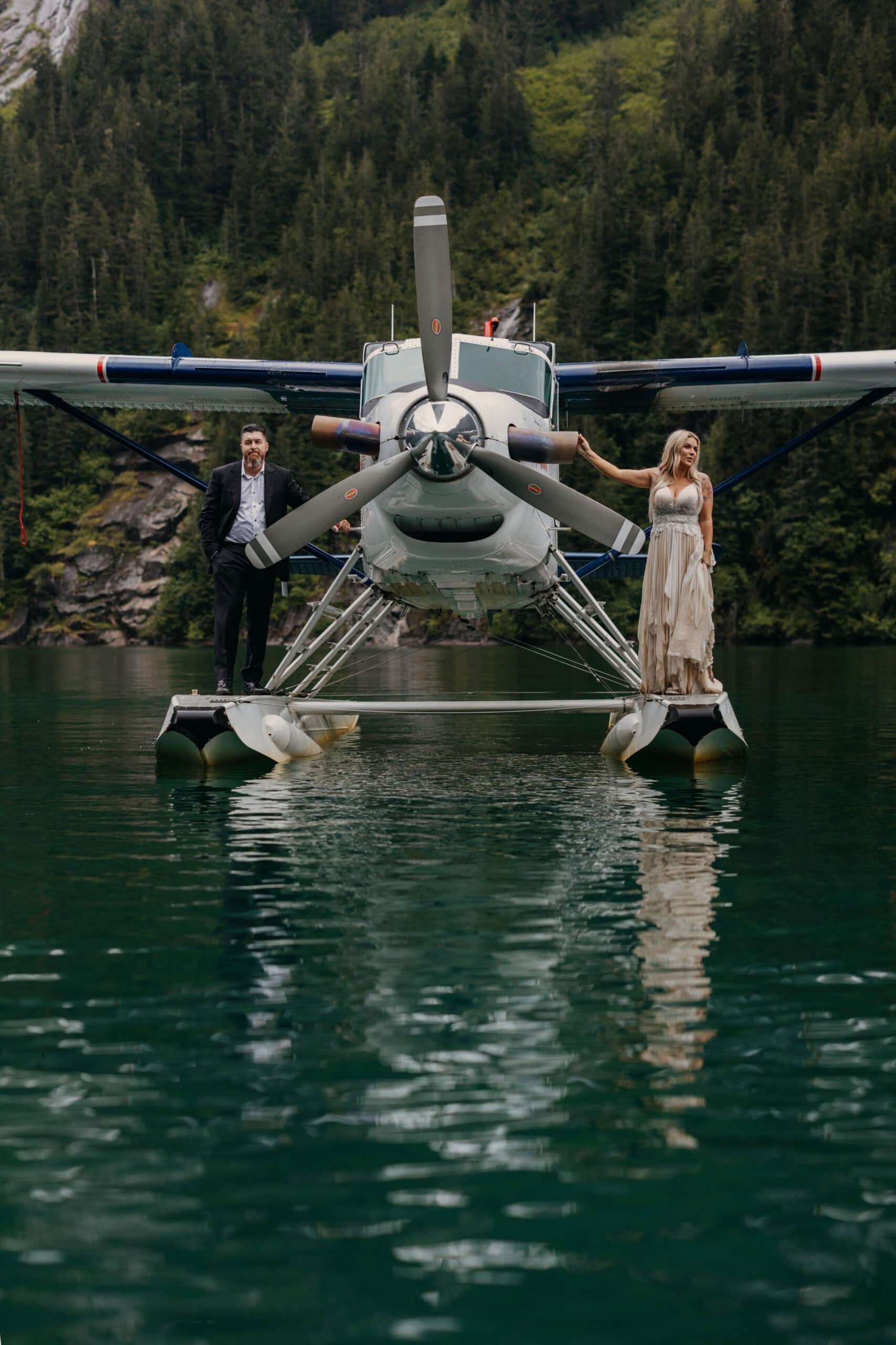 A couple stands on a seaplane in Alaska after getting married.