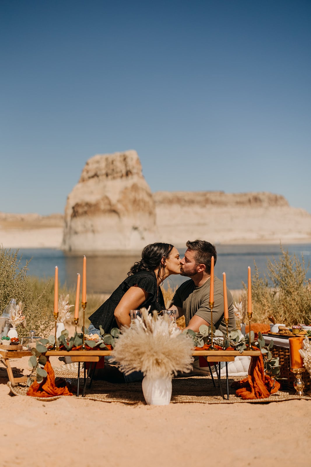 A couple shares a lunch picnic together on a sunny day at Lake Powell.