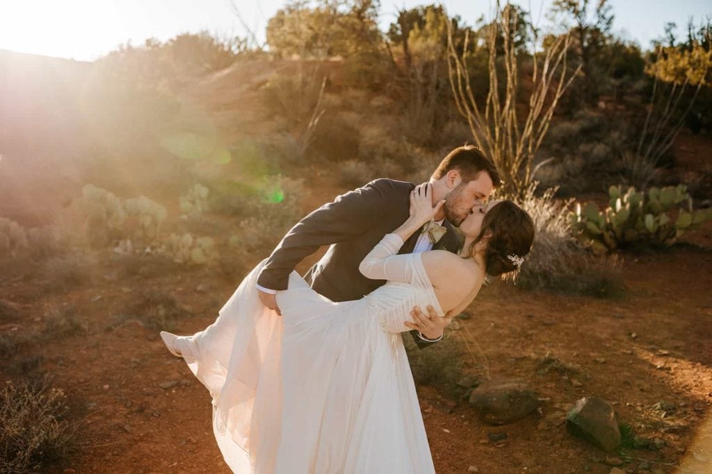 a dip kiss between a bride and groom.