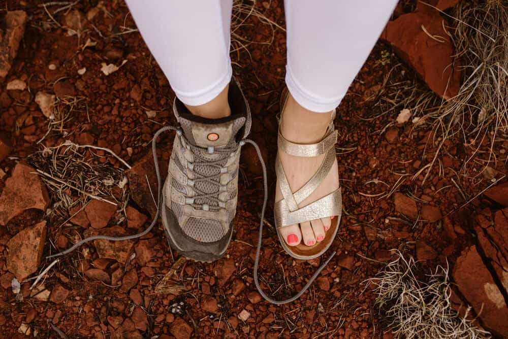 A bride wears one sandel and one hiking boot.