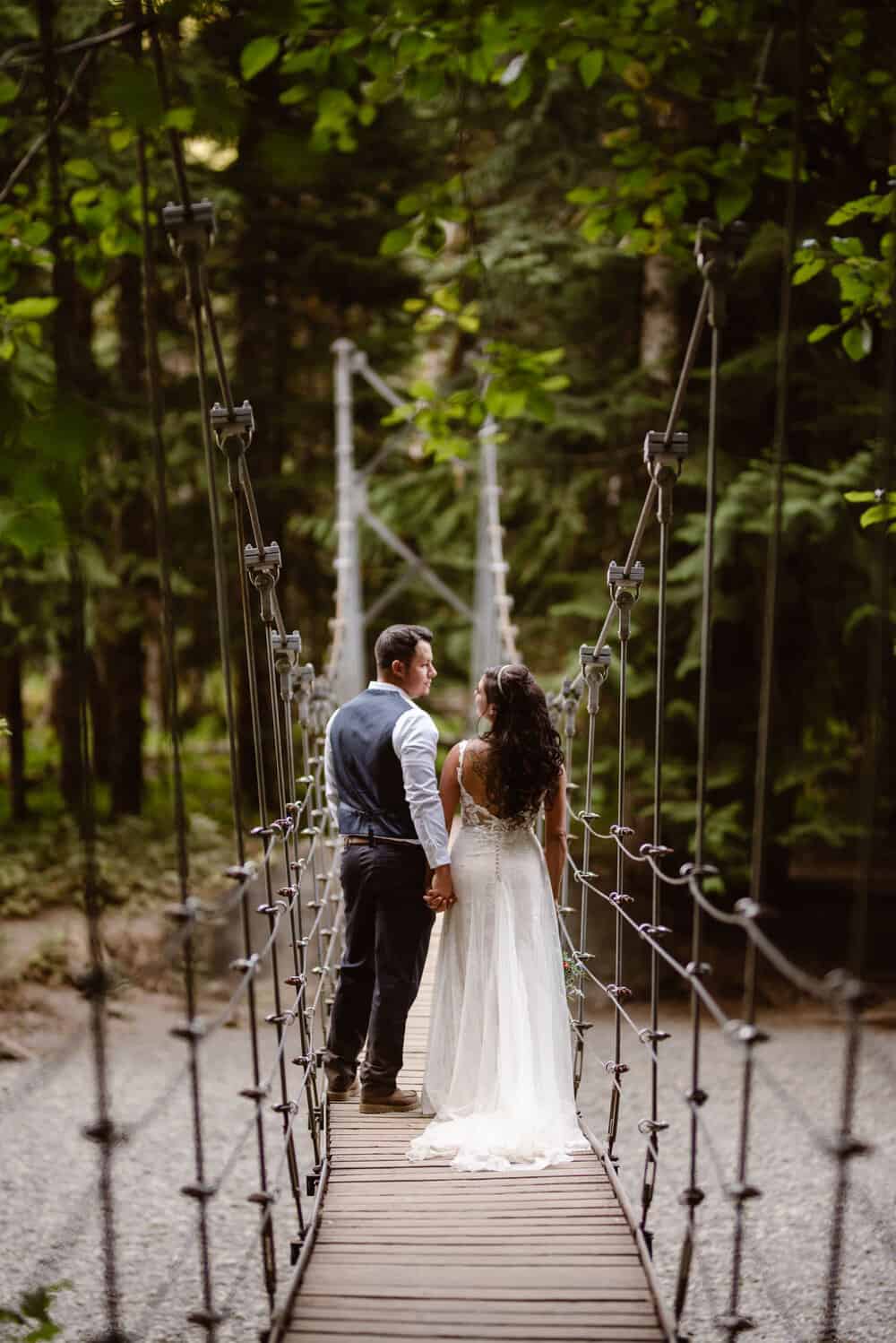 A bride and groom on a swinging bridge near Packwood, WA.