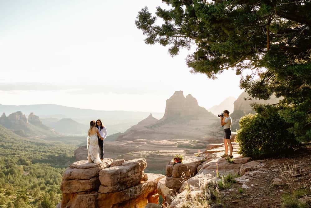 A behind the scenes photo of the photographer taking photos of the couple.