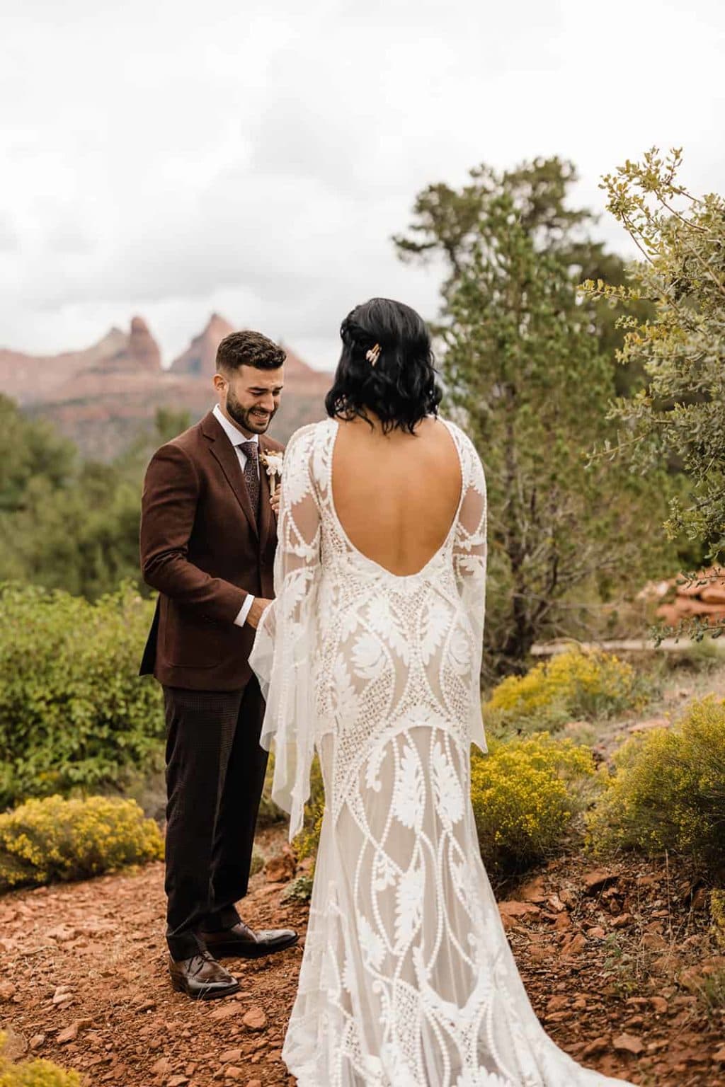 A bride and groom celebrating their first look in Sedona