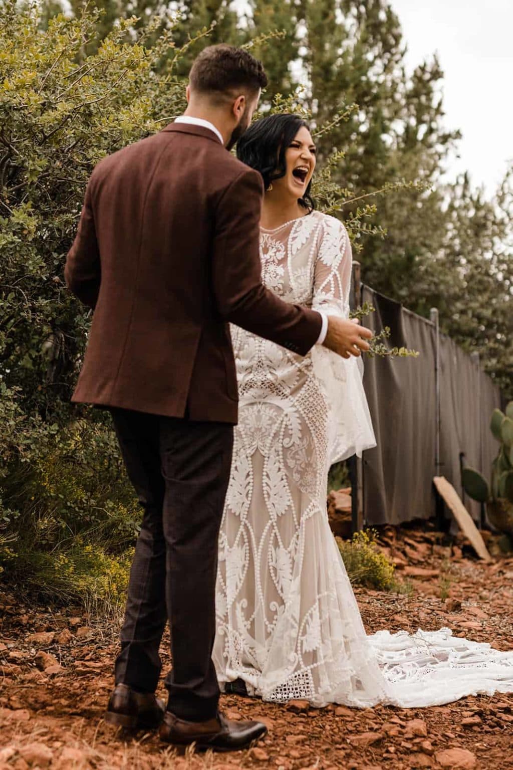 A bride and groom celebrating their first look in Sedona