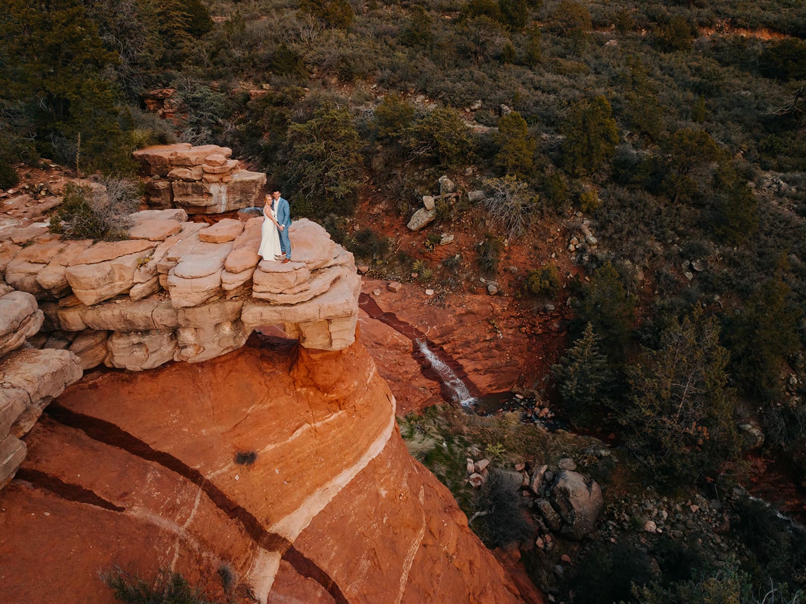 A view of of the waterfalls in Sedona behind the couple.