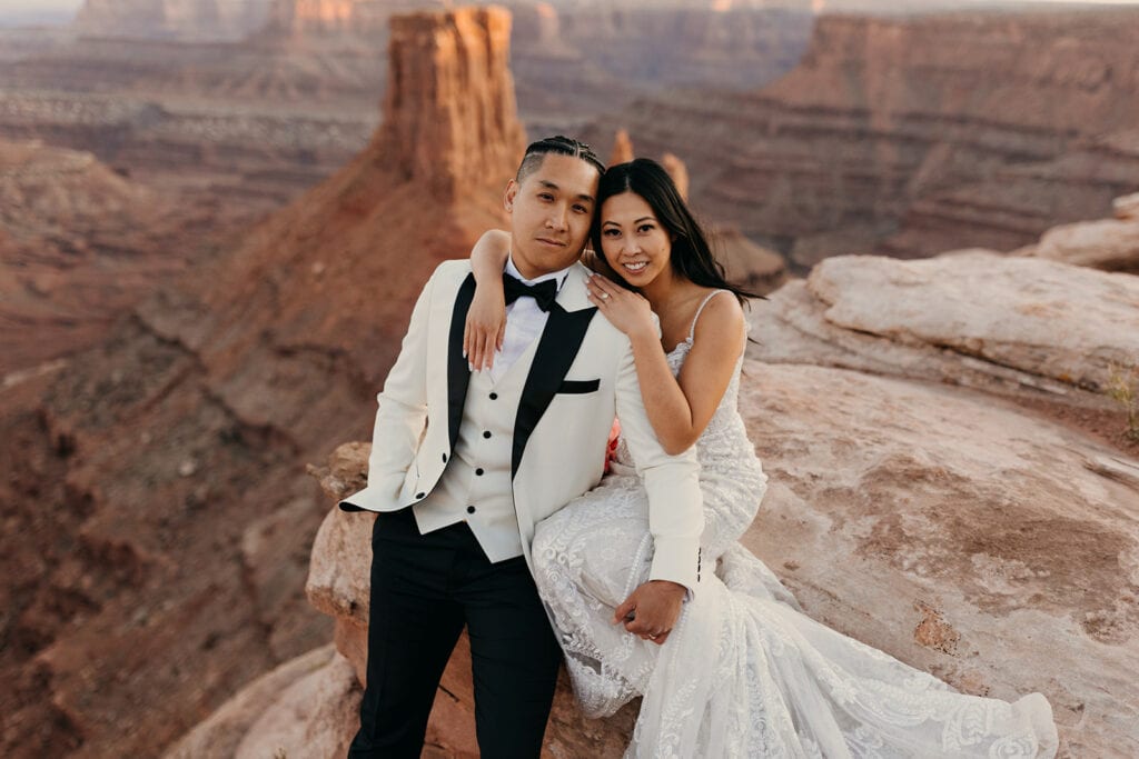 A portrait of the couple smiling at the camera. 
