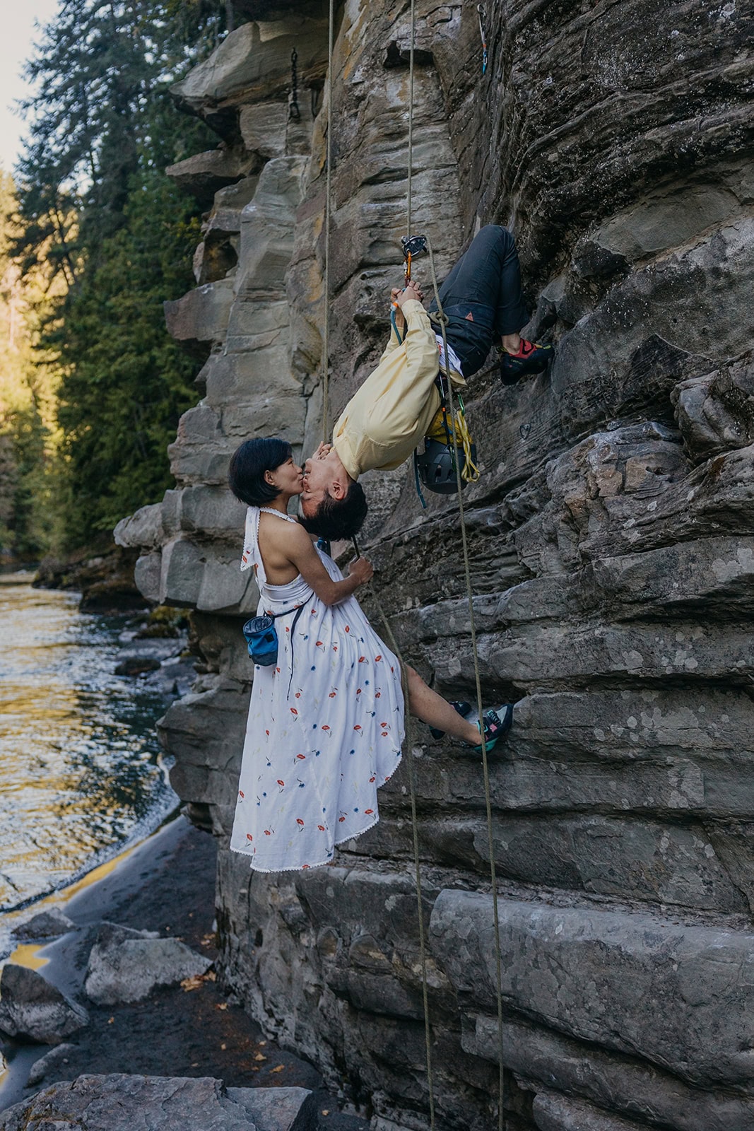 A couple shares a kiss during their rock climbing elopement near Olympic National Park