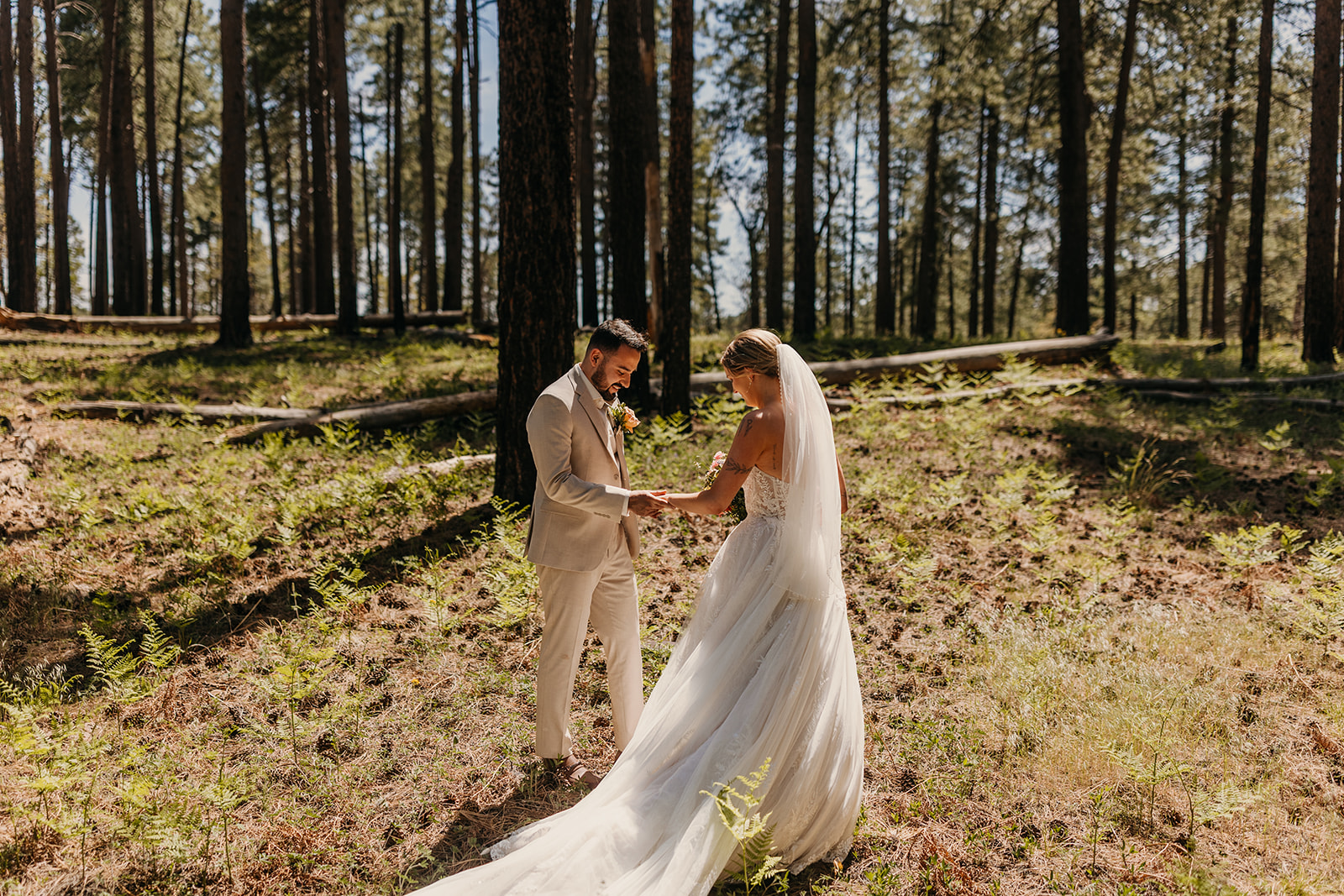 A groom admires his brides dress during their first look.