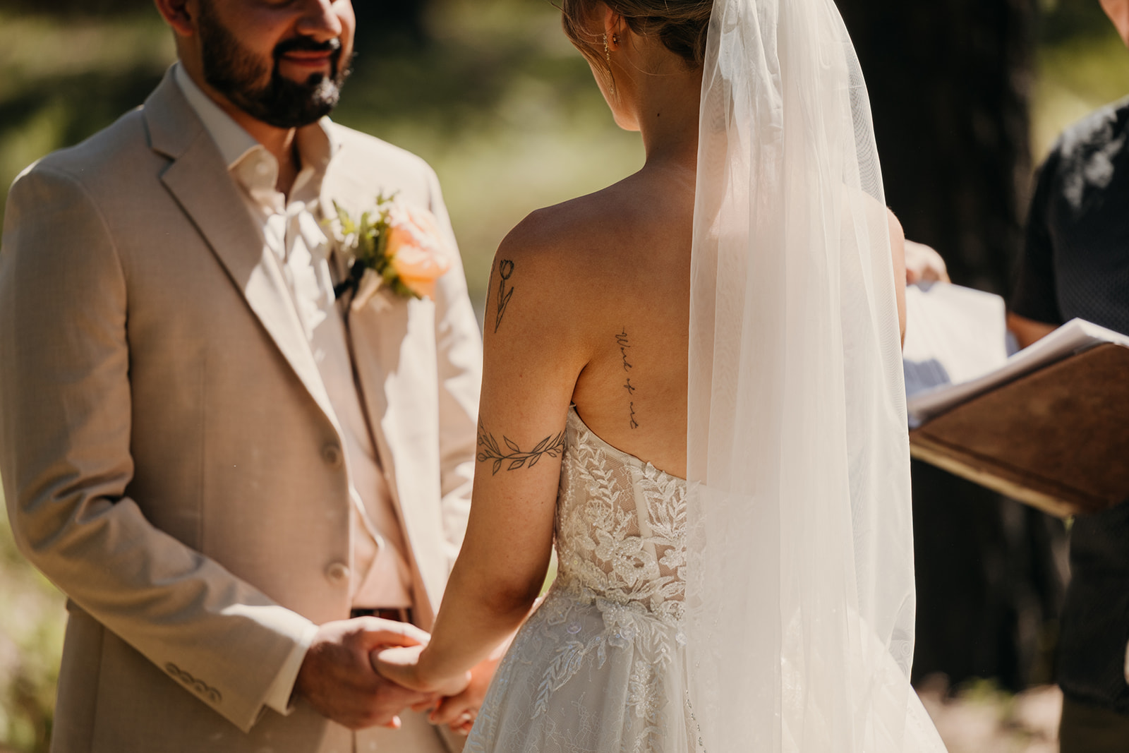 A detail photo of the bride's tattoos during their ceremony.