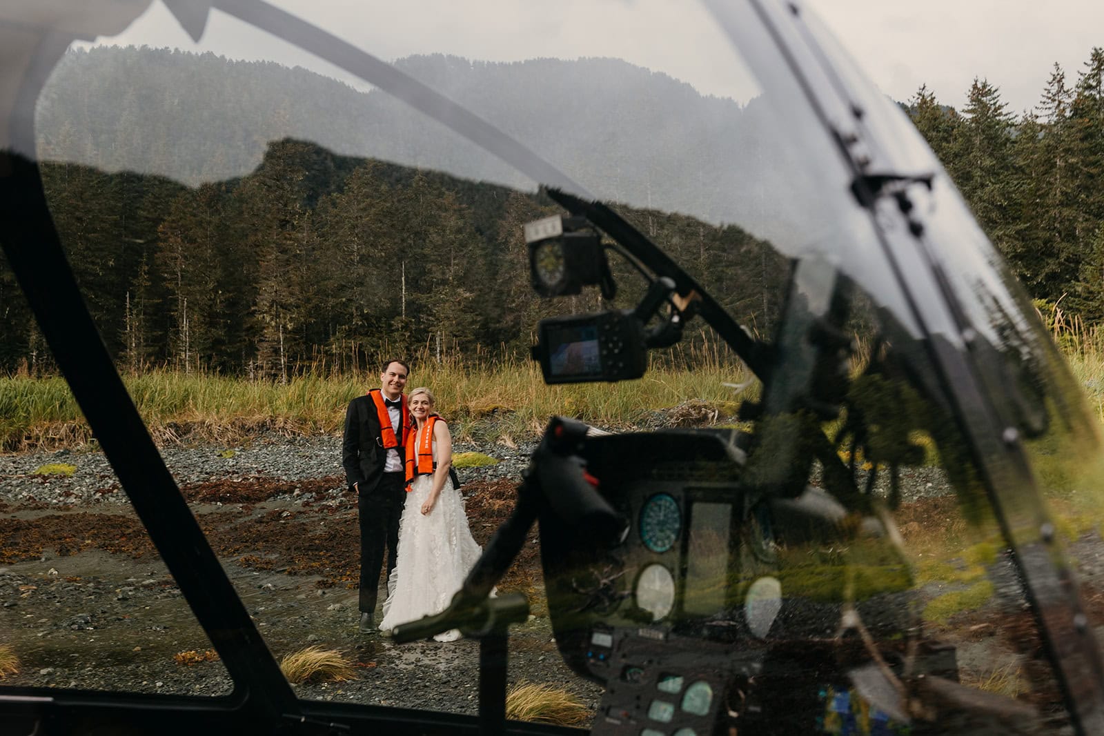 A photographer takes a photo through the helicopter window of the couple already exited. 