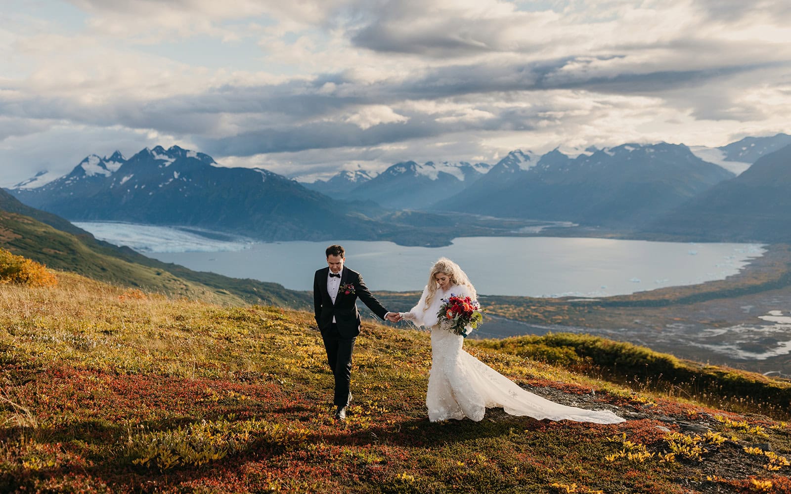 A couple walks across a mountain ridge in Palmer, Alaska only accessible via helicopter.