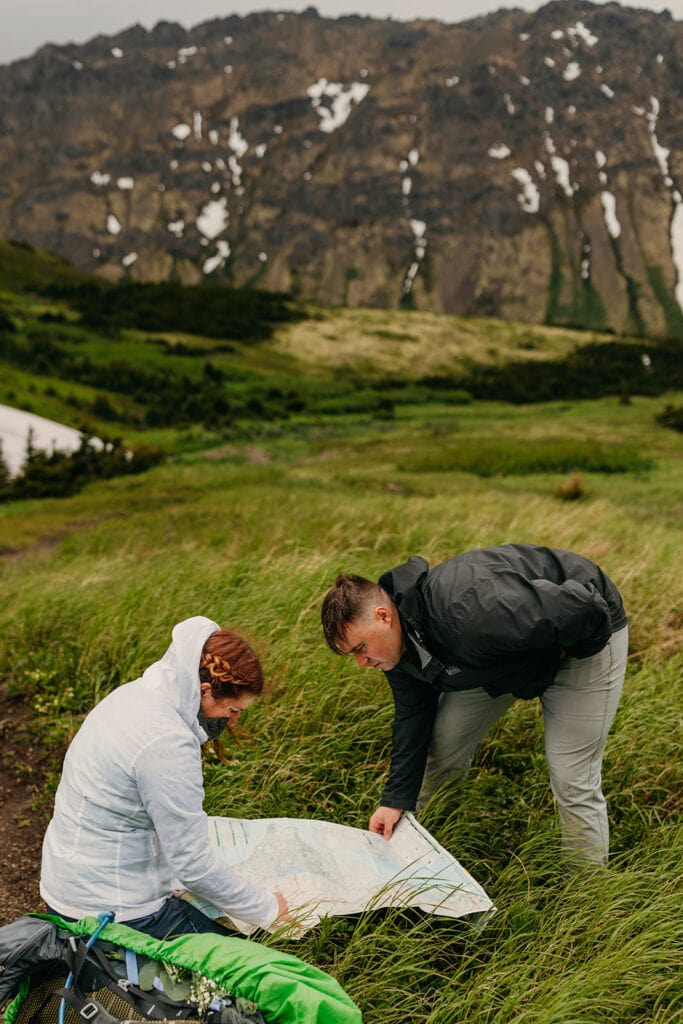 The bride and groom look over a map of the trial.