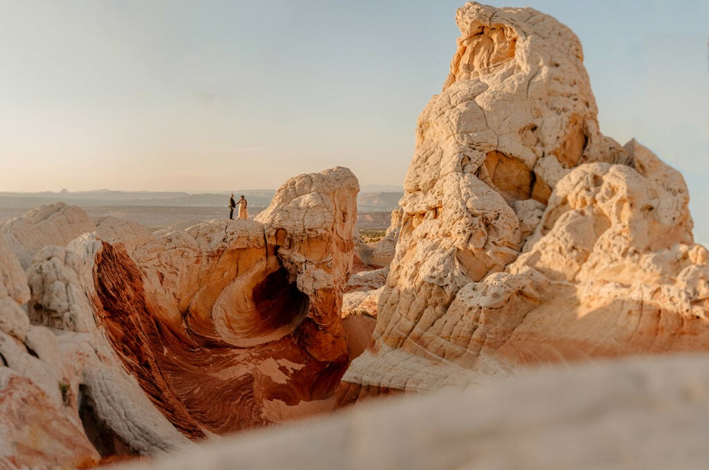 A couple stands on a vista of color rocks.