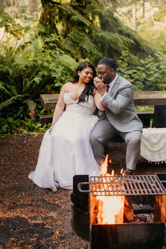 A couple enjoys a fire at their campsite in Olympic National Park.