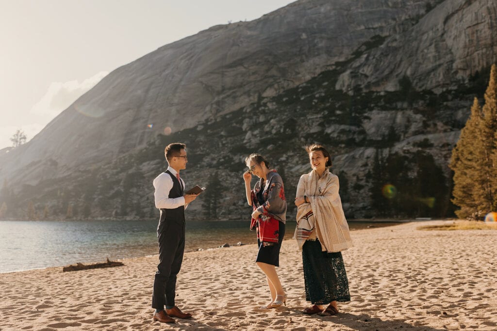 A grooms mother wipes her tears during the ceremony.