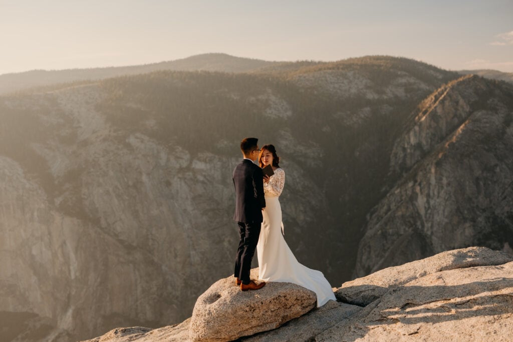 A bride reads her vows to her husband. 