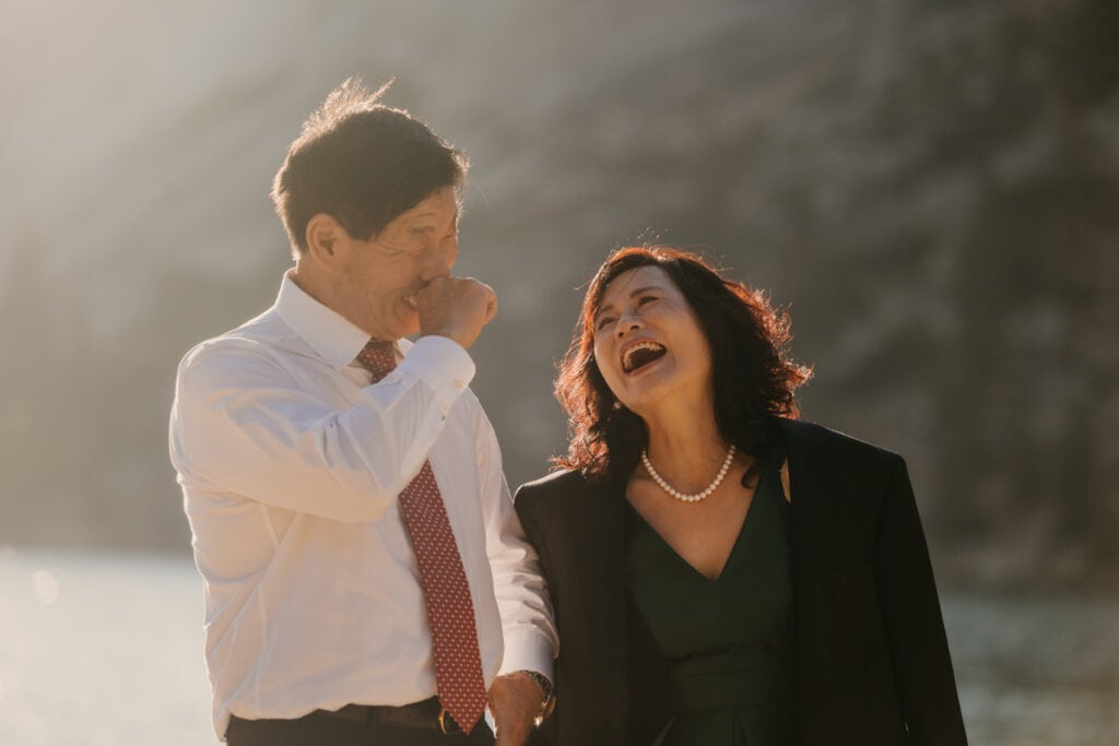 A mother laughs during her daughters wedding ceremony. 