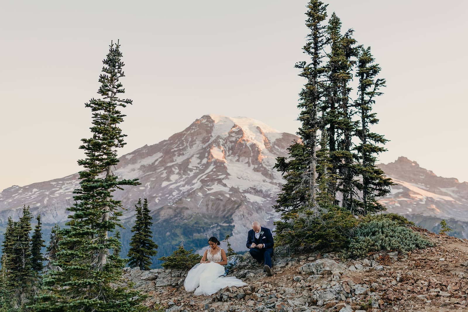 A bride and groom sit together to write their vows before their elopement ceremony.