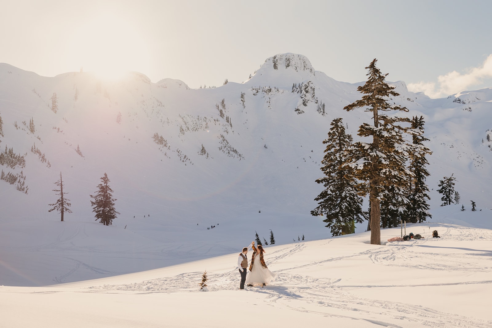 A couple gets ready in the snow together for their elopement.