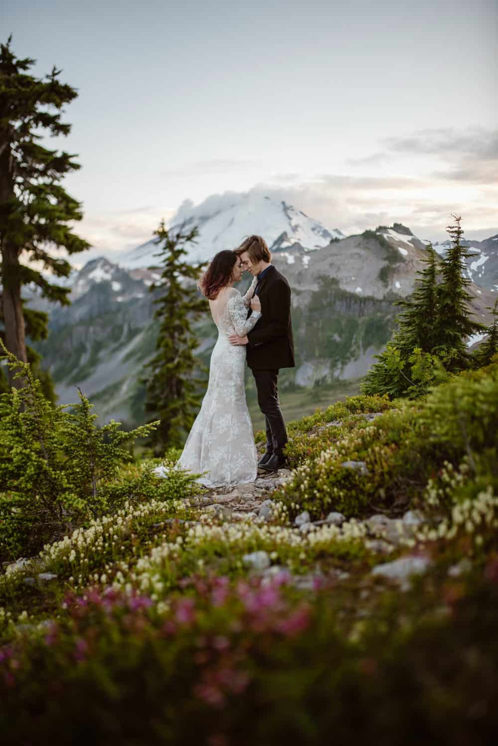 A couple puts their foreheads together standing near the meadows of MT Baker.