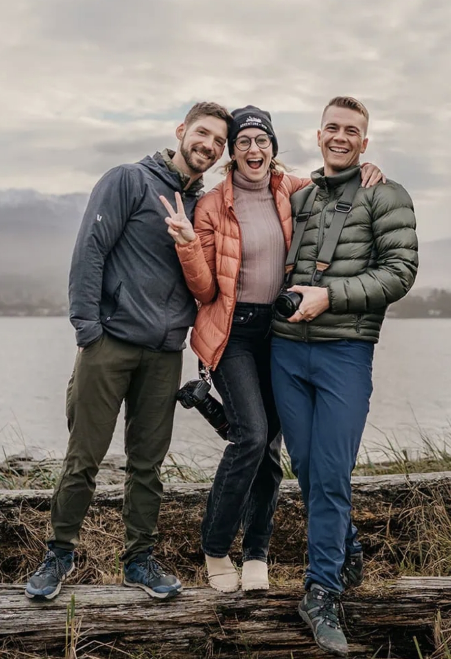 Traci, Malachi, and Bill all pose with a lake behind them.