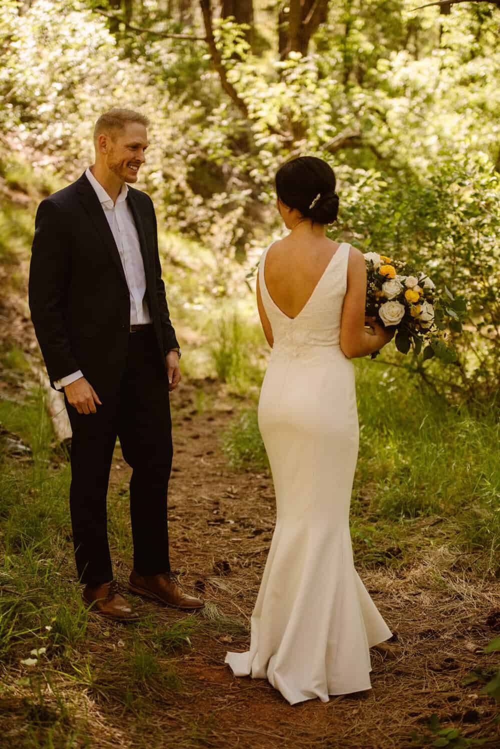 The bride shows off her dress at the couple's first look. 